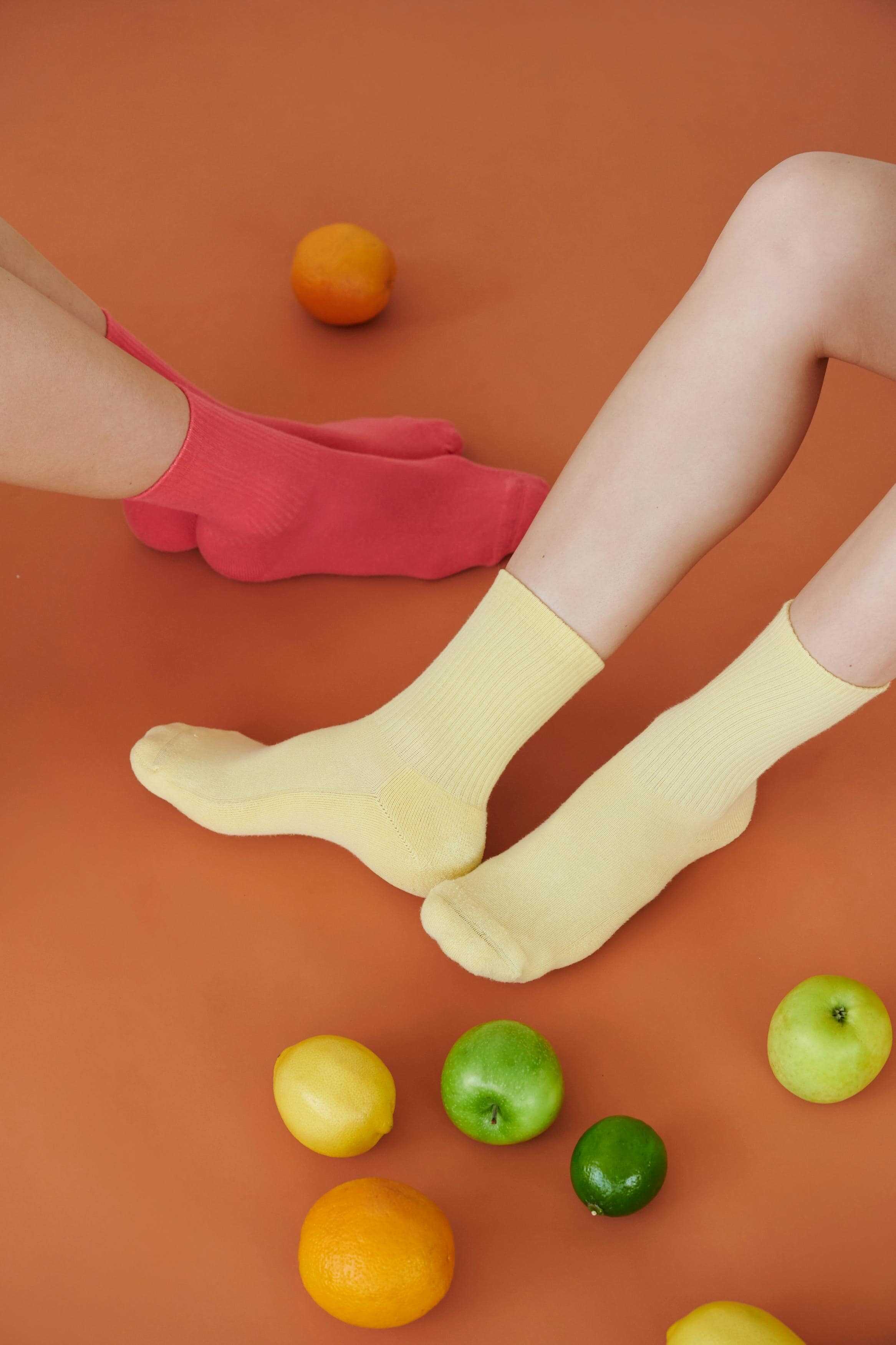 two pair of feet in colorful socks