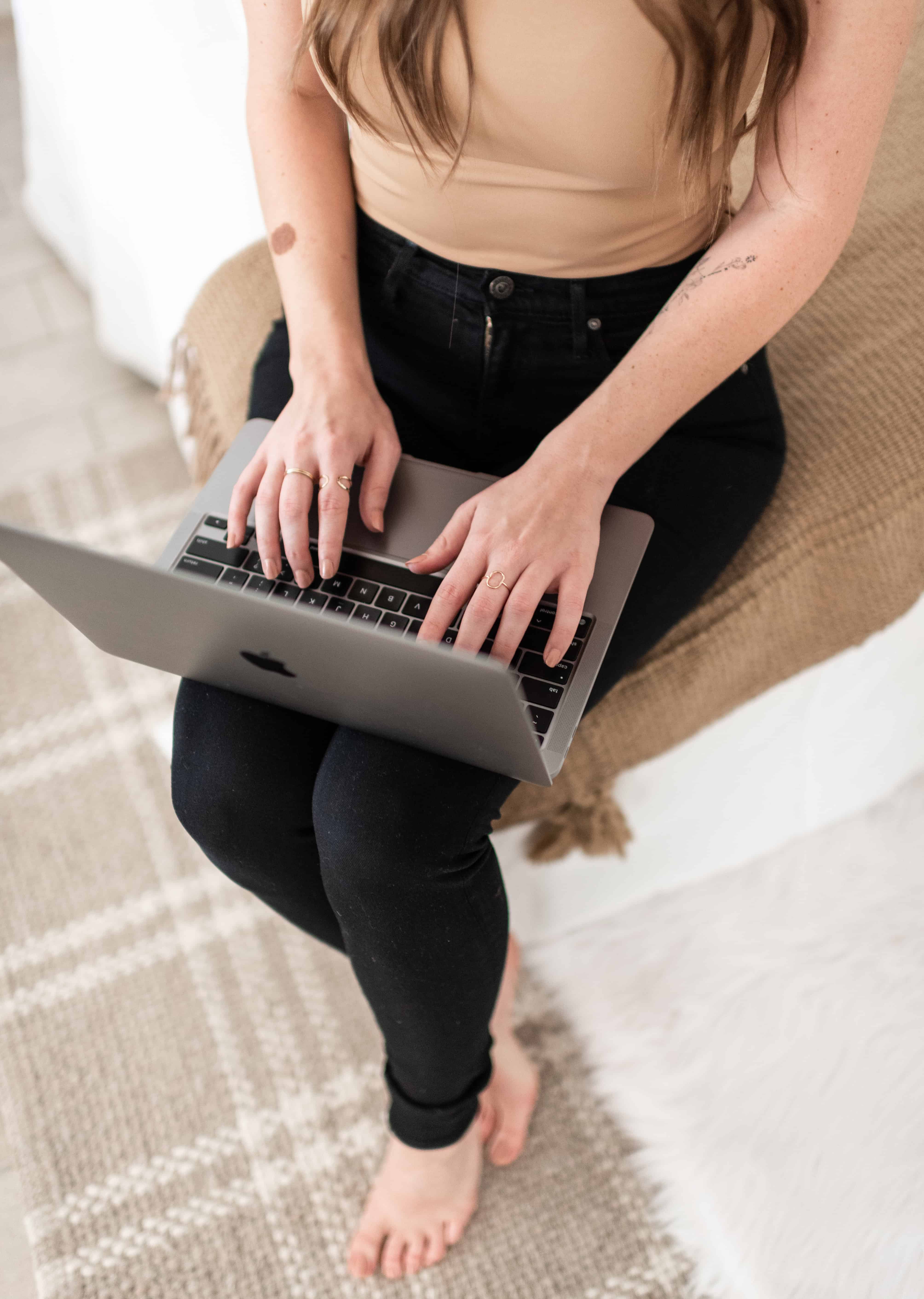 woman typing on a laptop