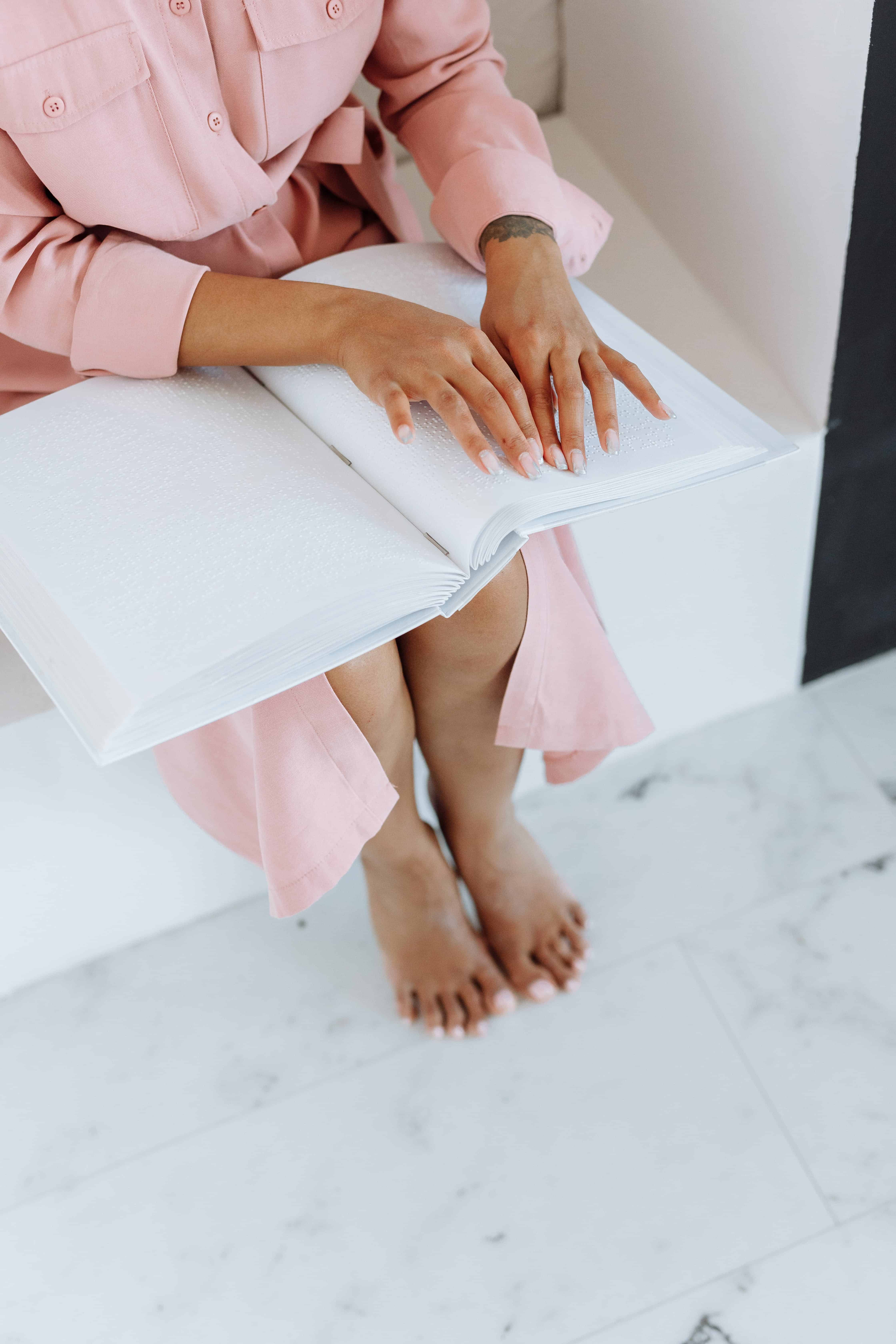 woman reading braille