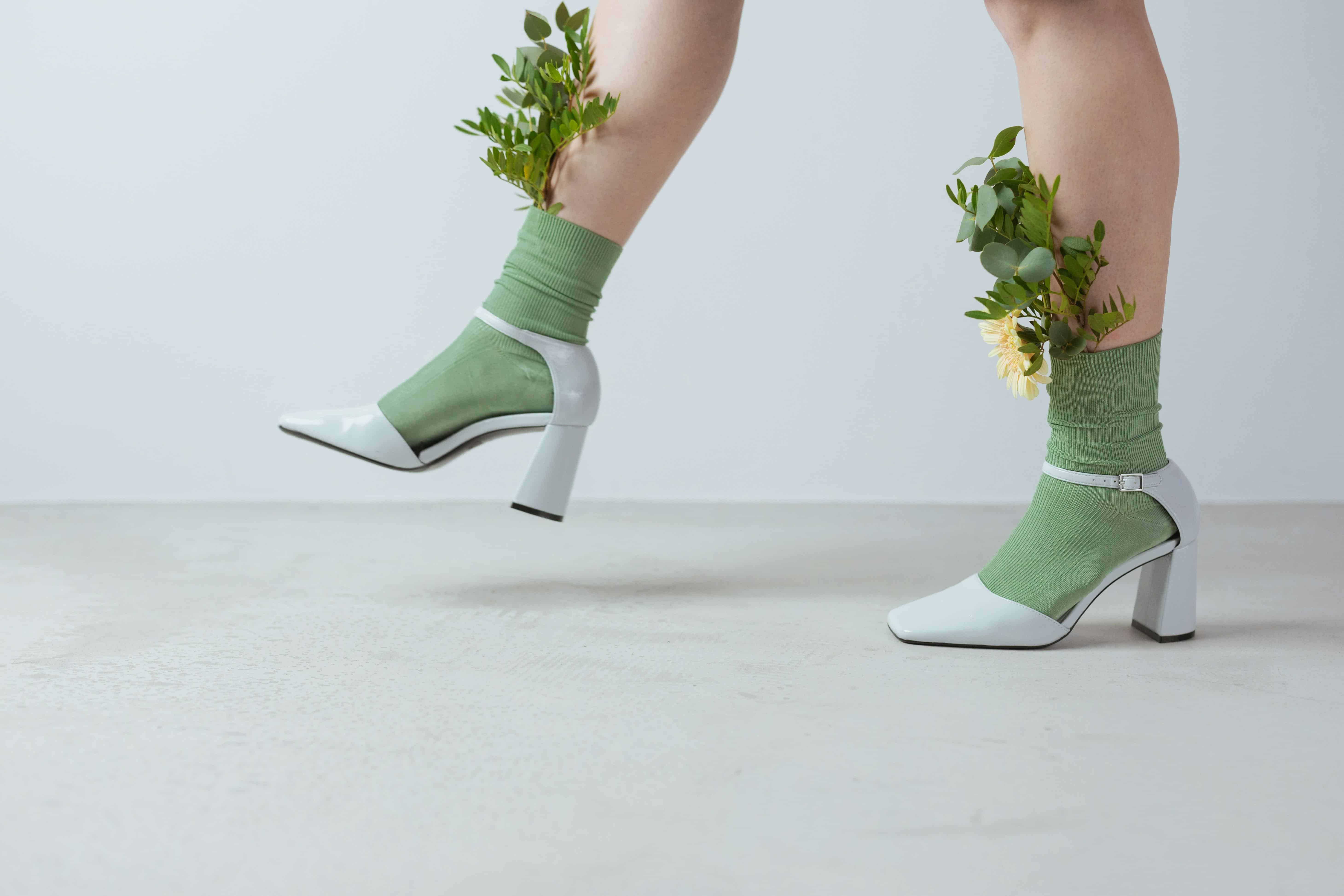 woman walking in heels and wearing socks that have flowers