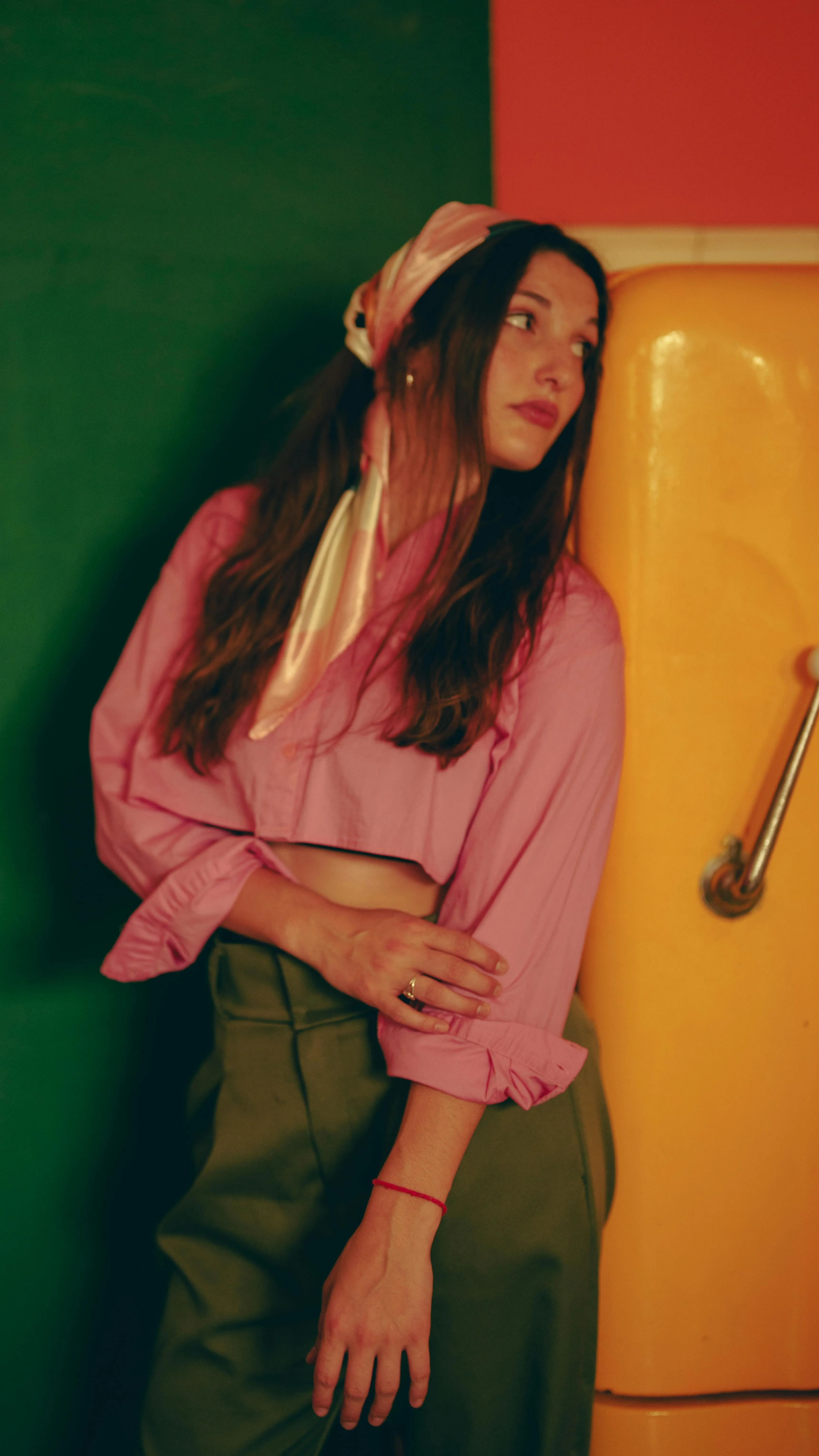 woman standing against a retro fridge