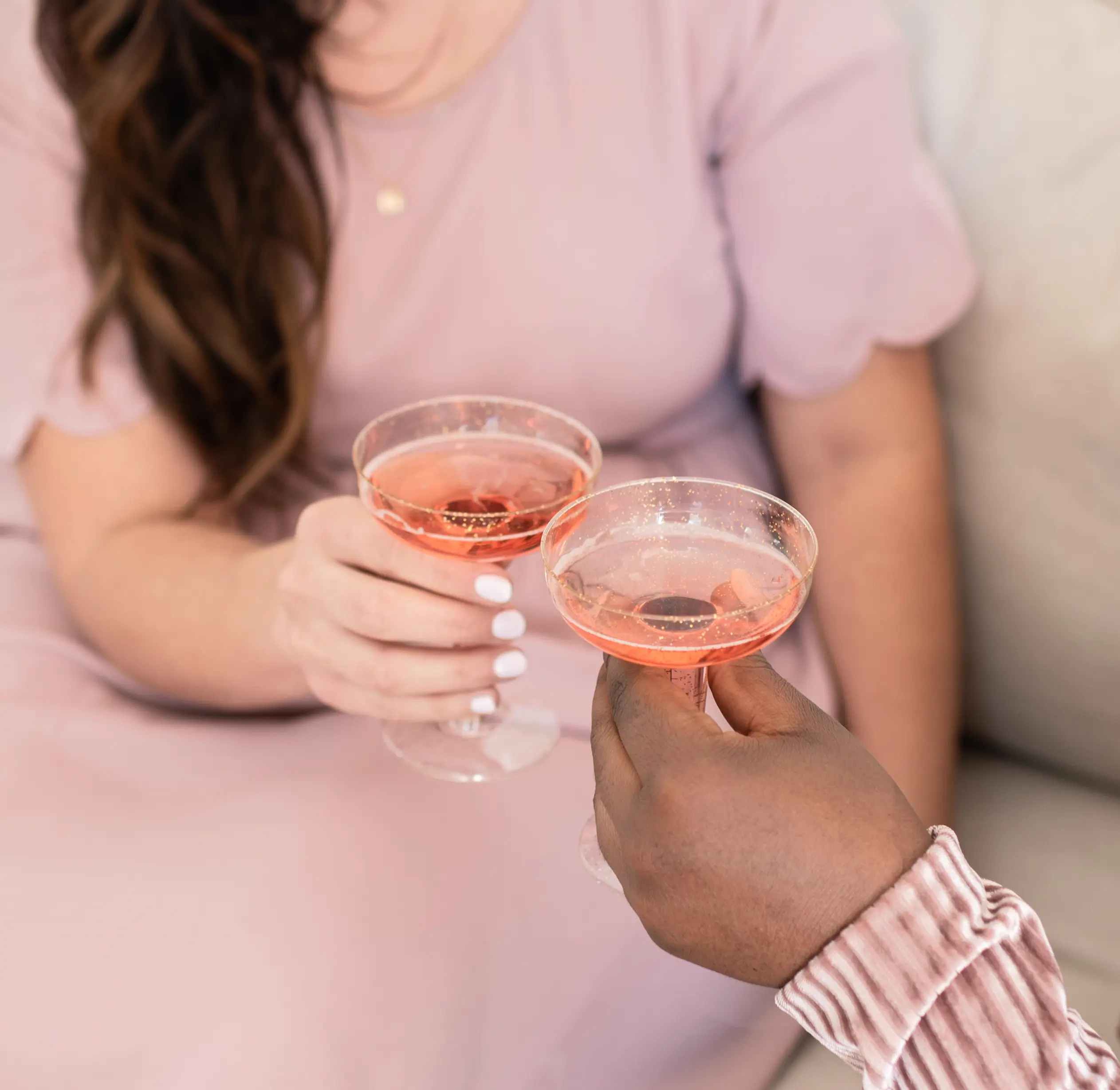 two women toasting with drinks