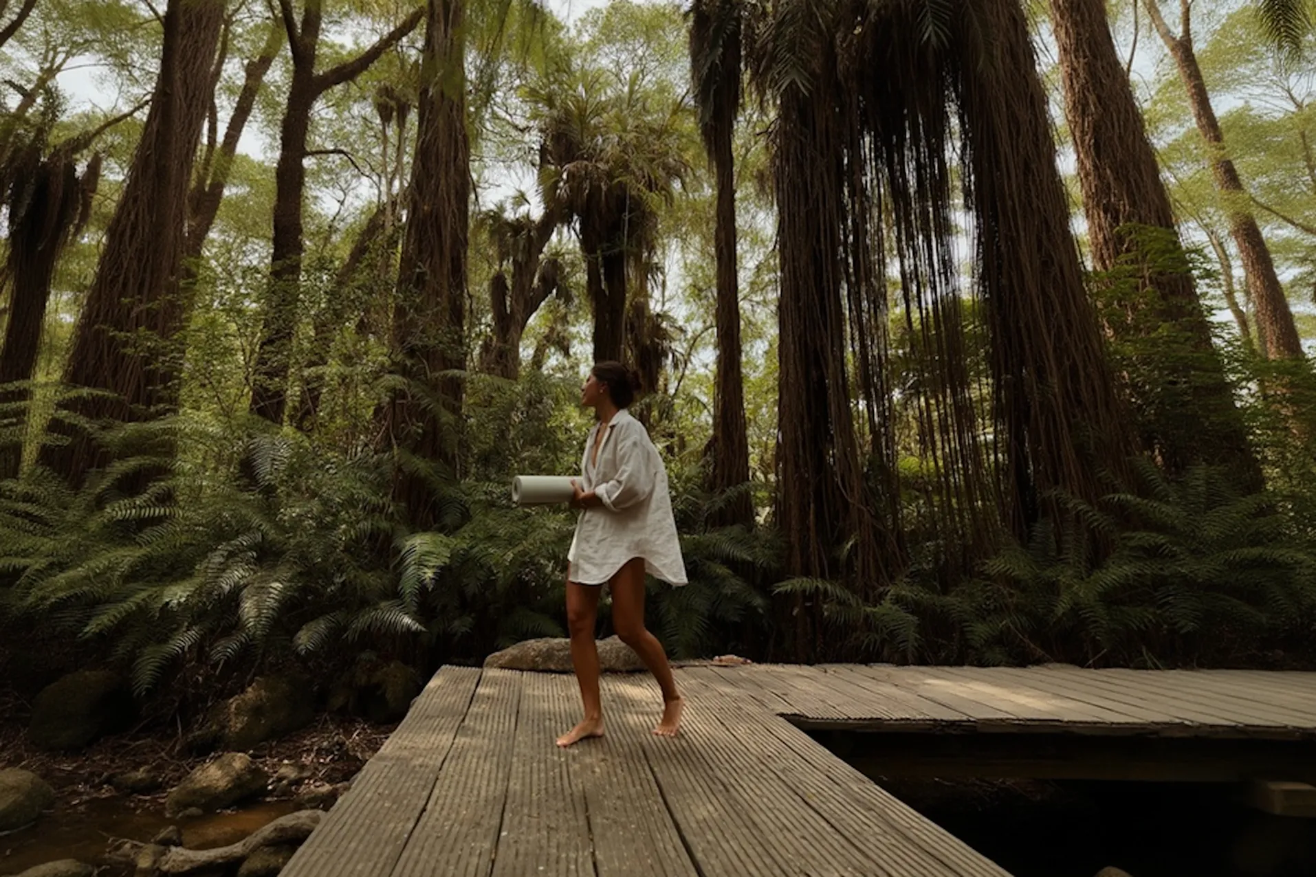 Woman practicing yoga in forest setting
