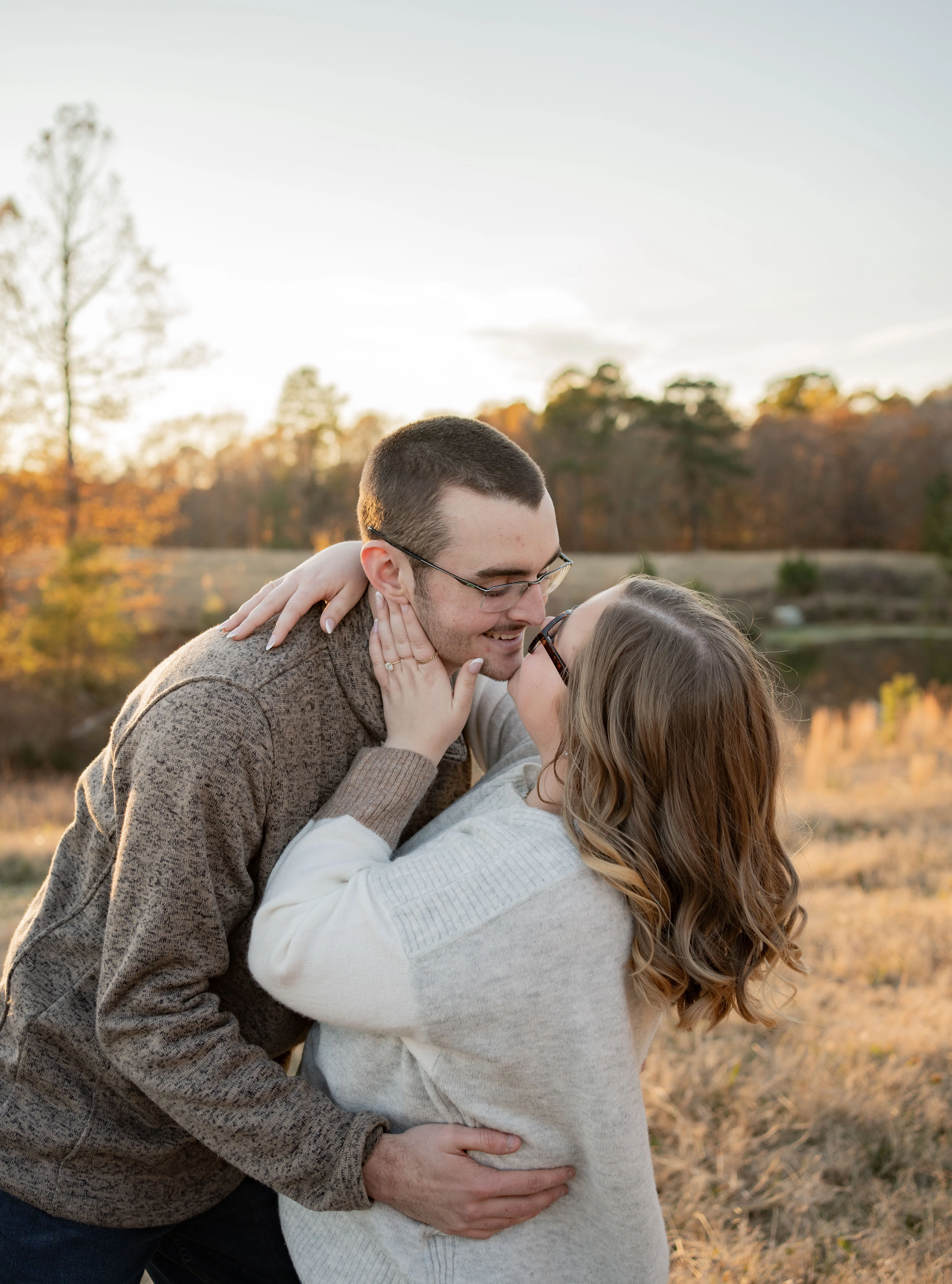 Smiling couple laughing in a field