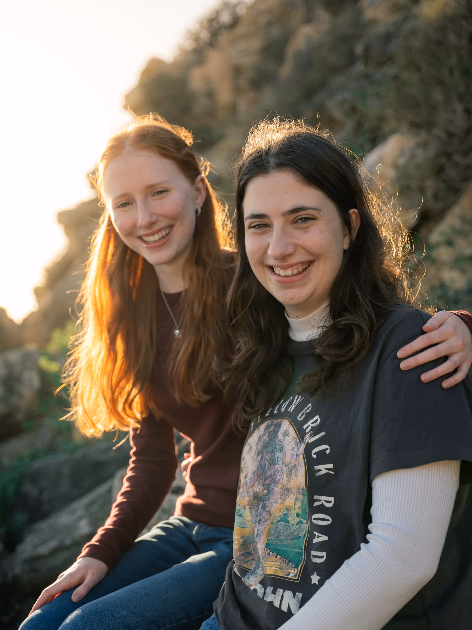 Portrait of two sisters at the cliffs, golden hour