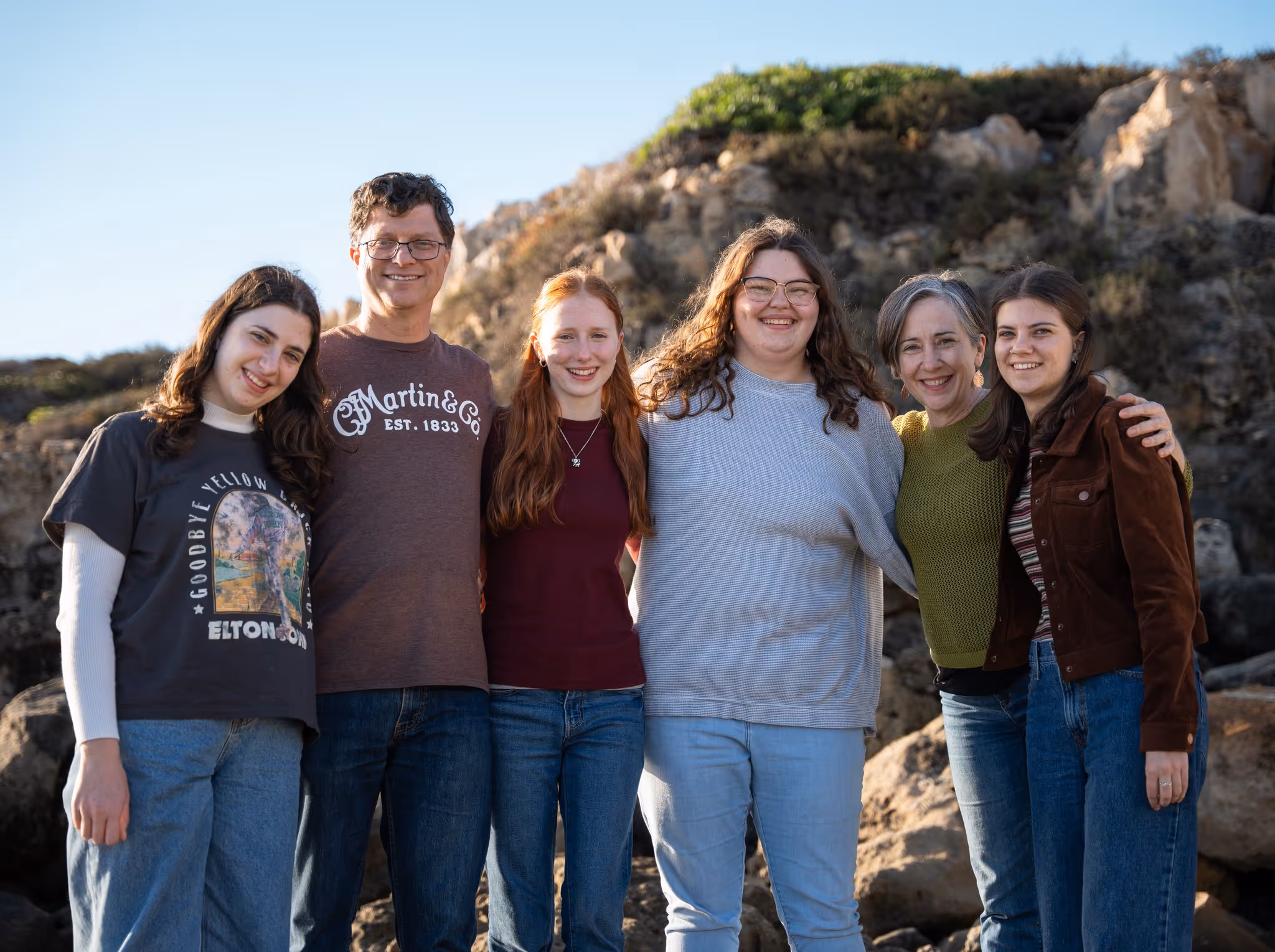 Family portrait at the cliffs by the sea at golden hour