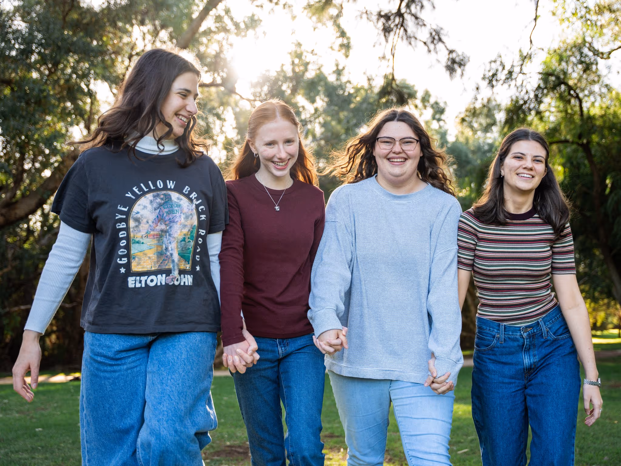 Candid portrait of four sisters in the park
