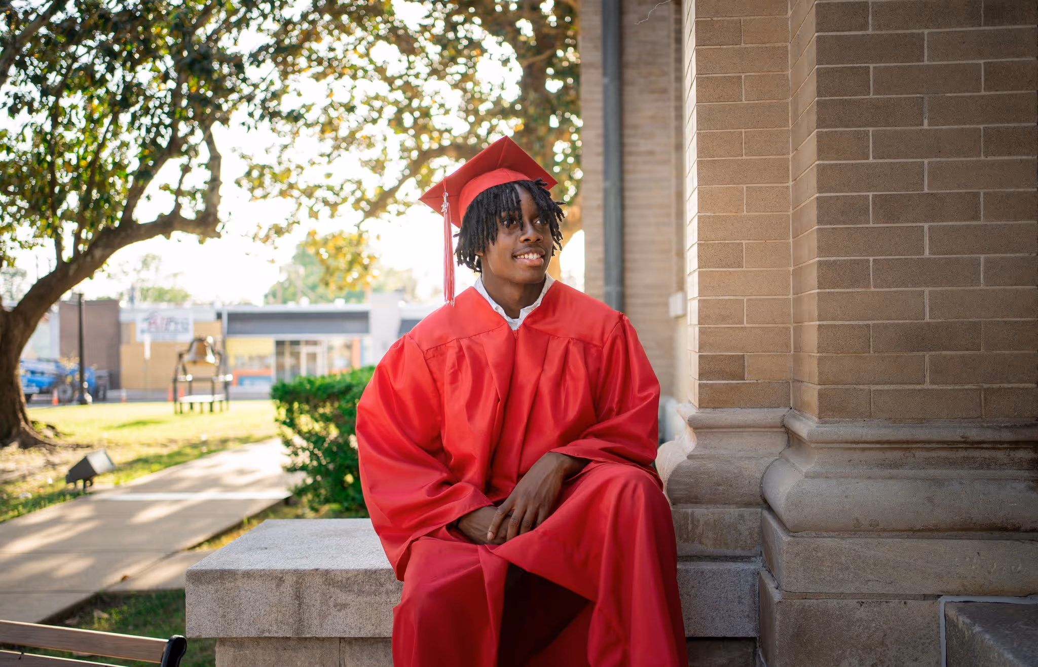 Portrait of a senior wearing a red gown.