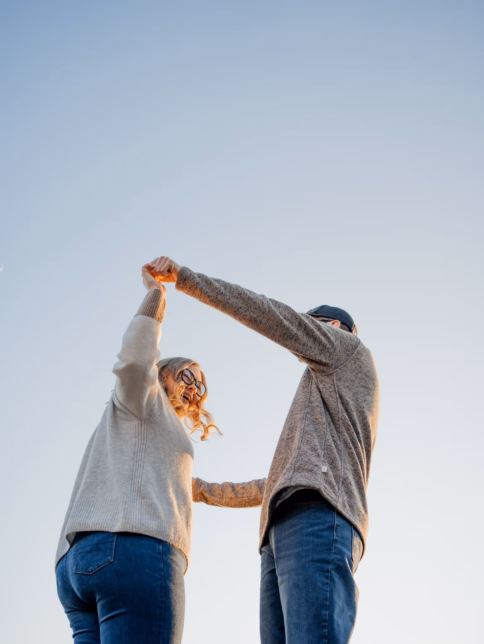 Couple's portrait against a light blue sky