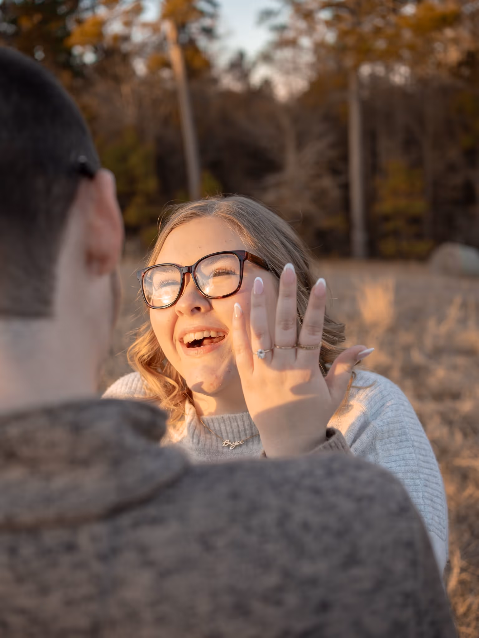 Couples portrait in a field at sunset