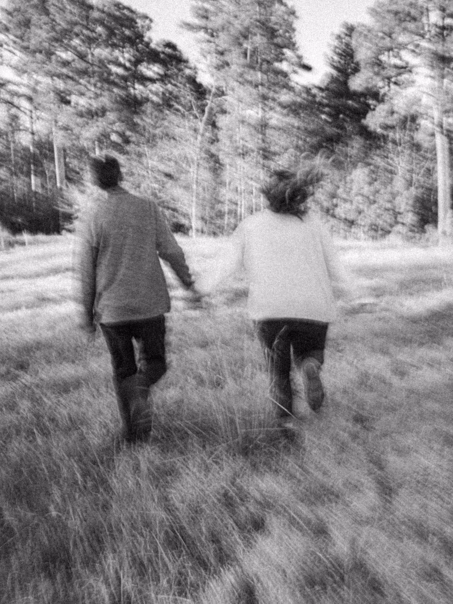 Black and white portrait of couple walking