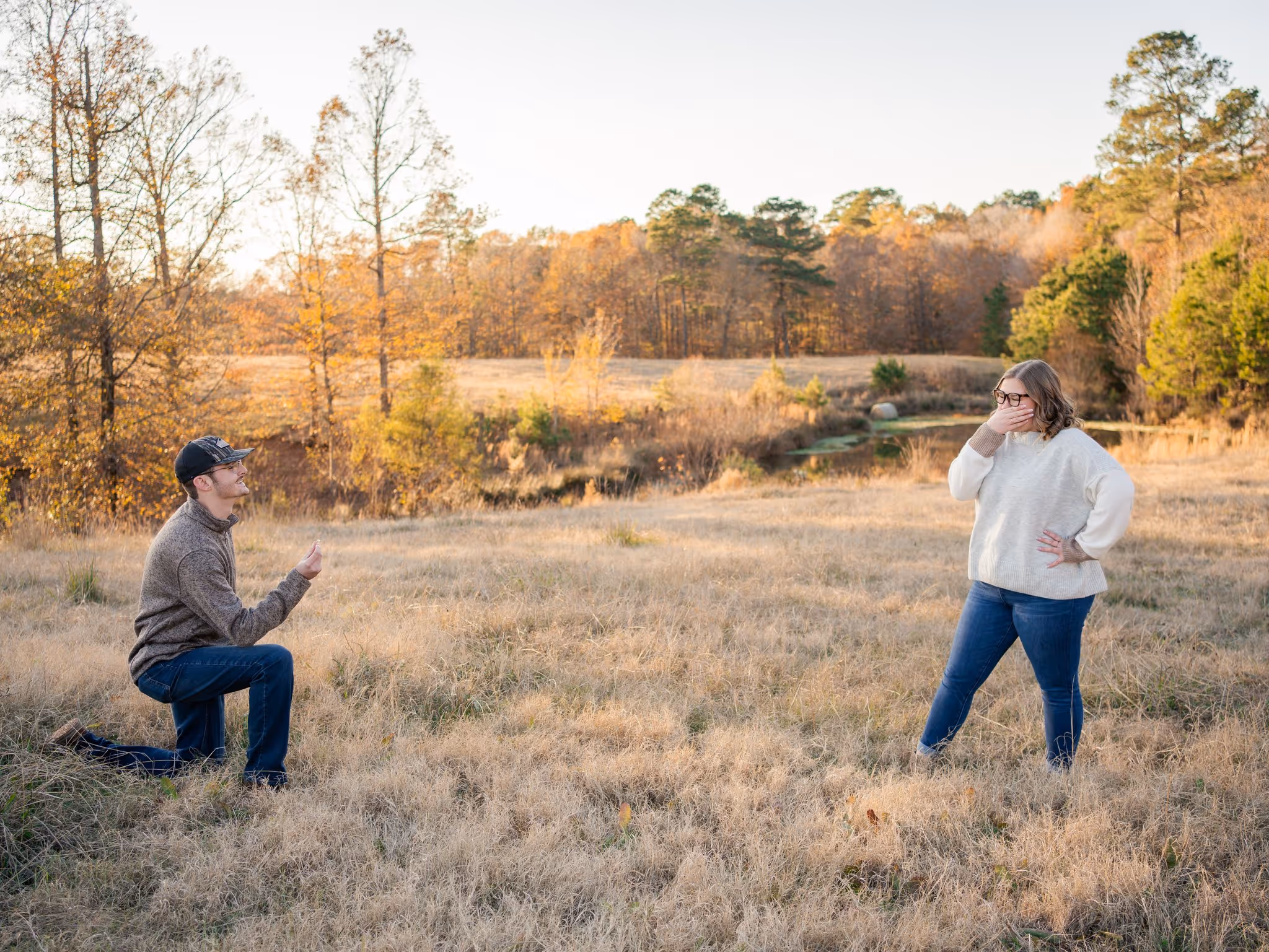 Couples portrait in a field at sunset