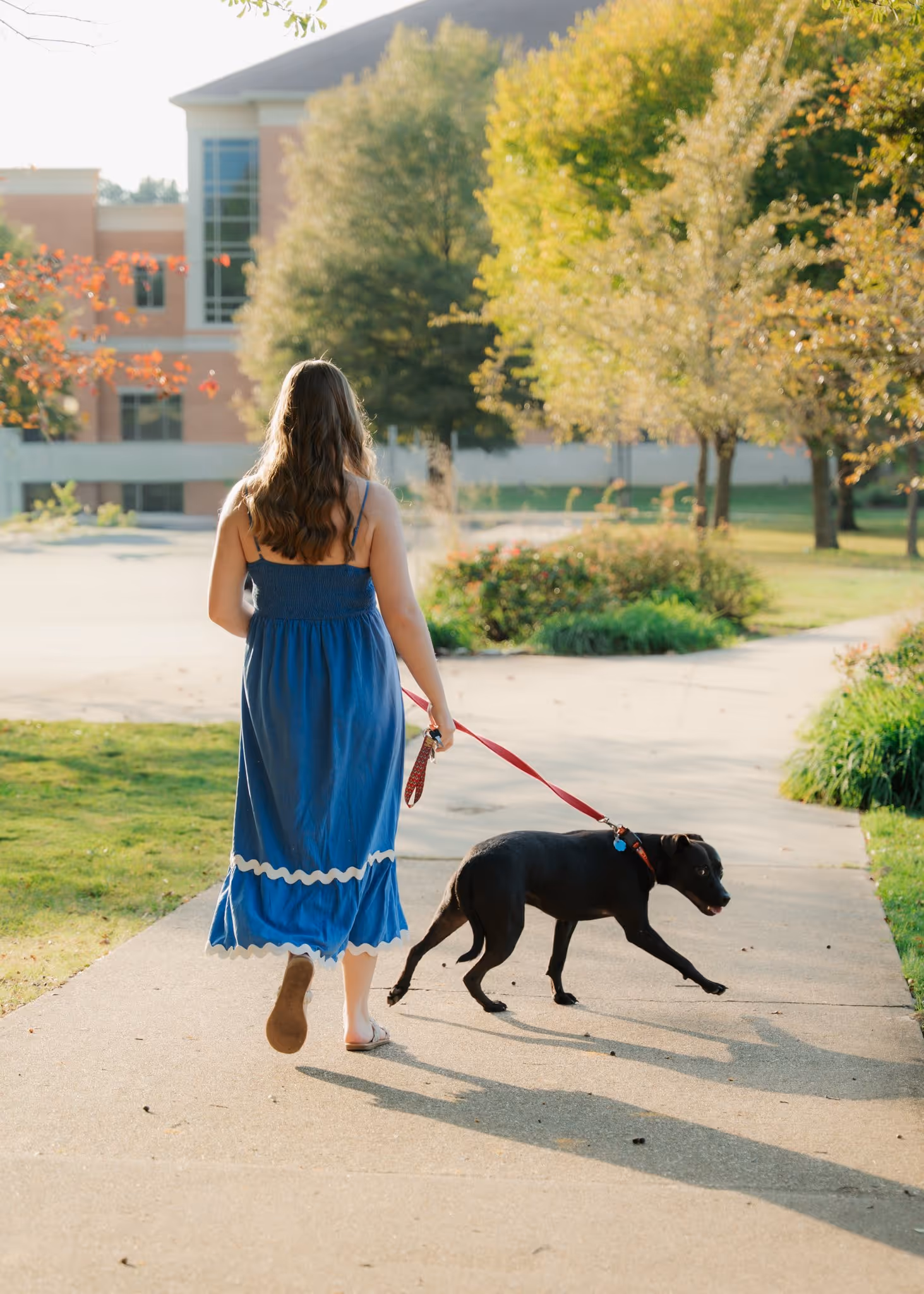 Portrait of a young woman walking a dog