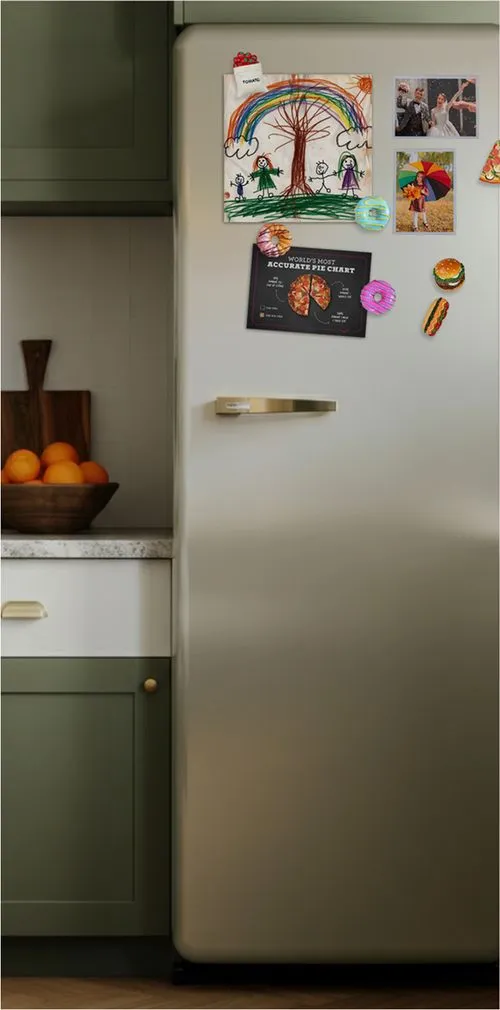 Refrigerator decorated with children's artwork, family photos, and food-themed magnets and an Amazon Restaurants mailer.