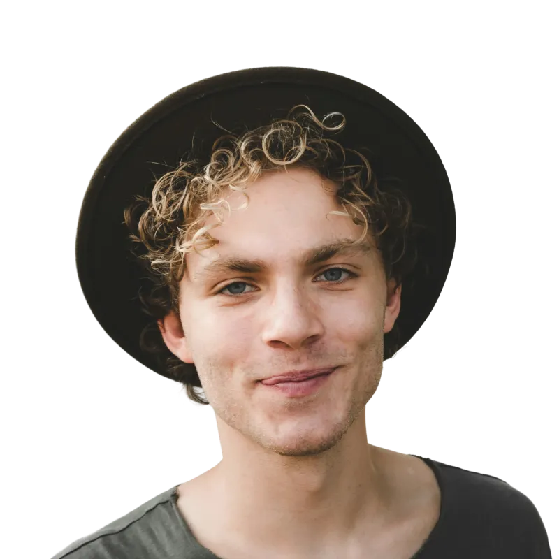 Young man with curly blond hair wearing a black wide-brimmed hat and a dark gray shirt, smiling softly.