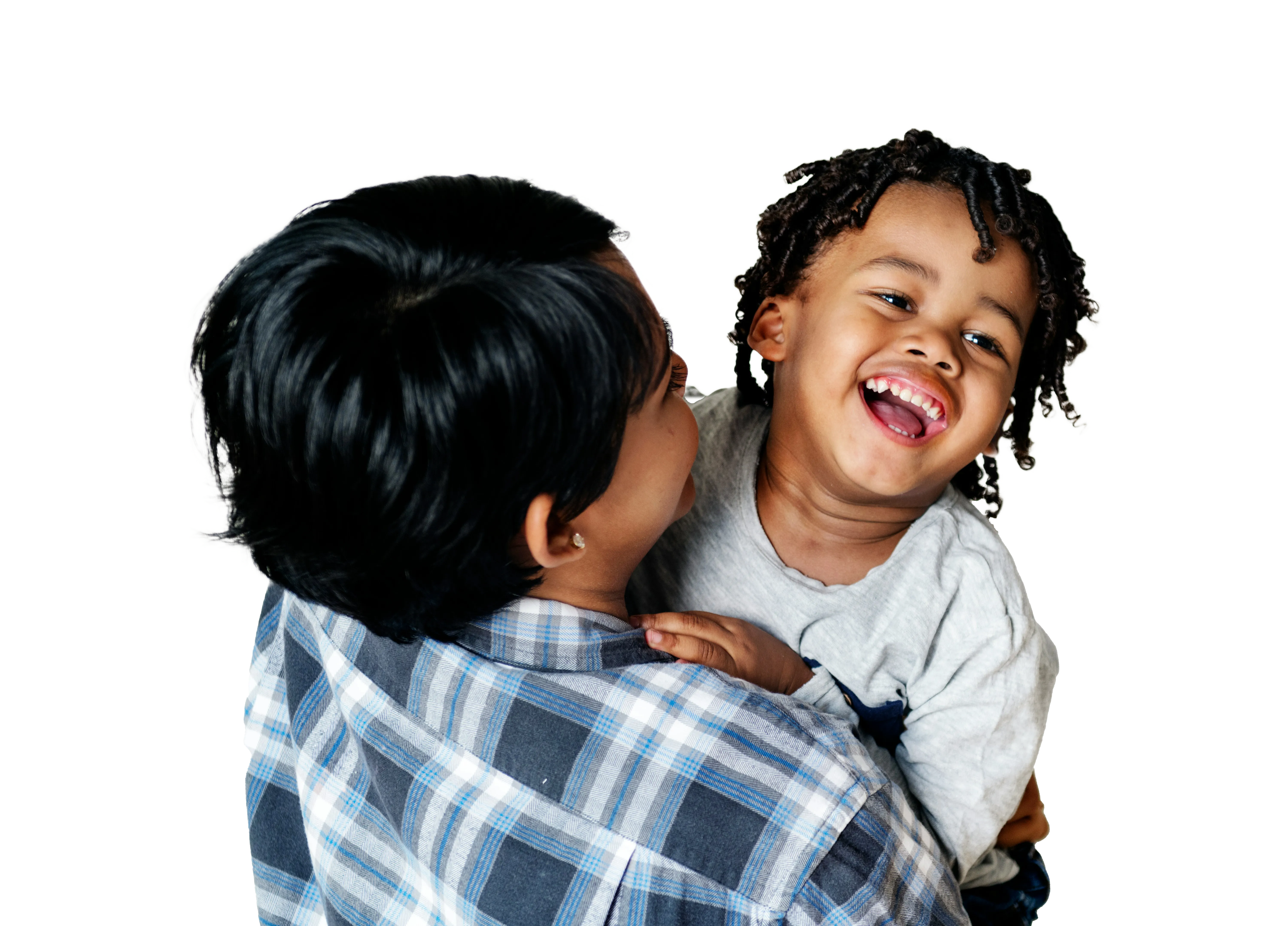 Woman holding and smiling at a laughing child with curly hair.