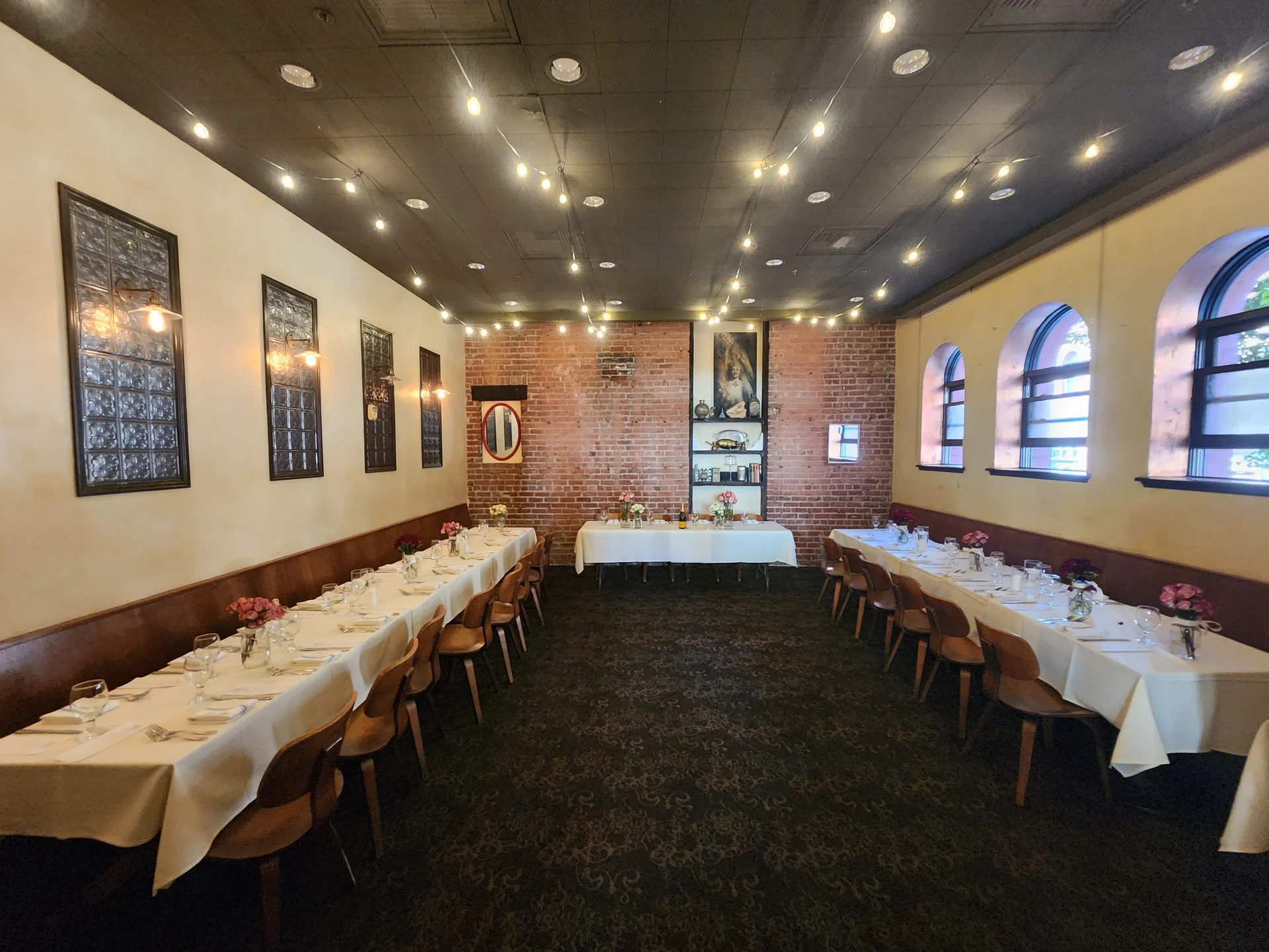 A restaurant with a long table and chairs.
