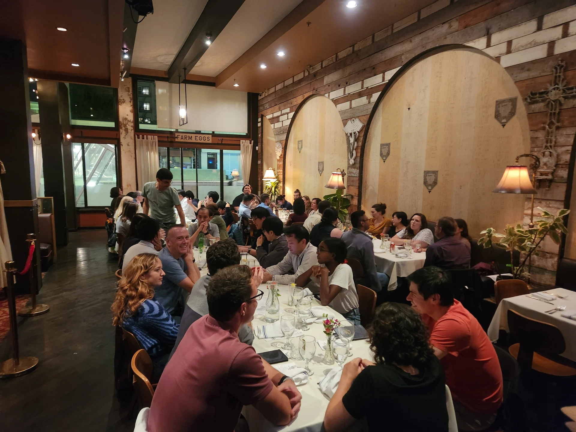 A group of people sitting around a table in a restaurant.