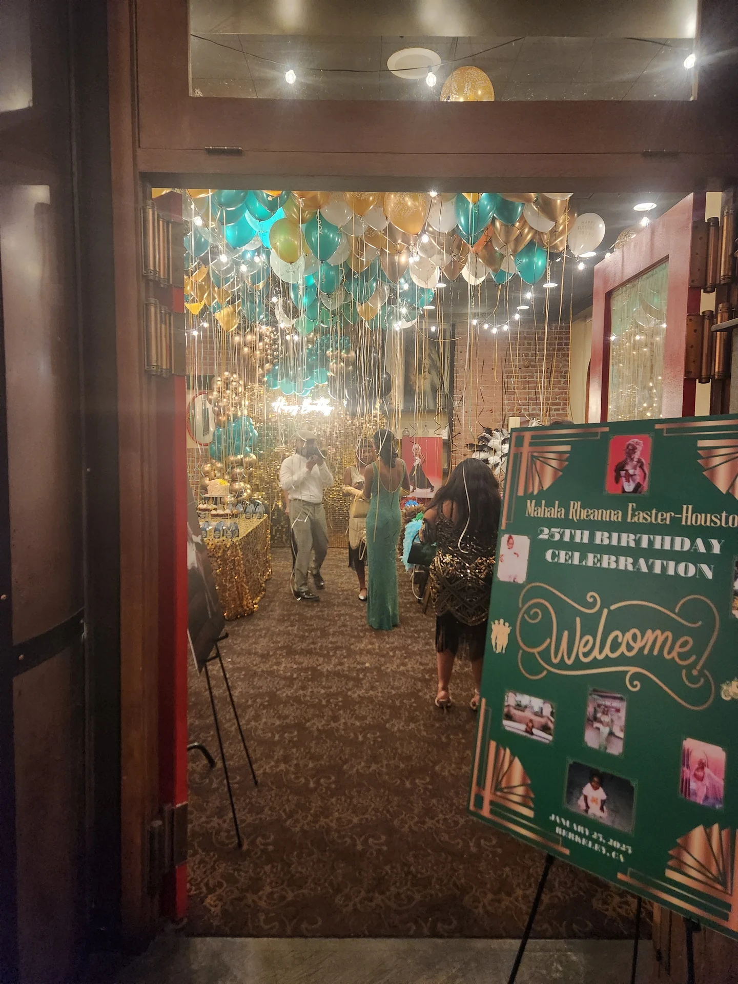 A birthday celebration is taking place in a room with balloons and streamers.