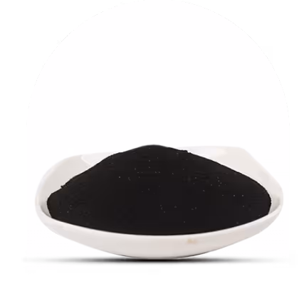 White dish filled with fine black powder on a white background.