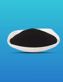 White dish filled with fine black powder on a blue gradient background.