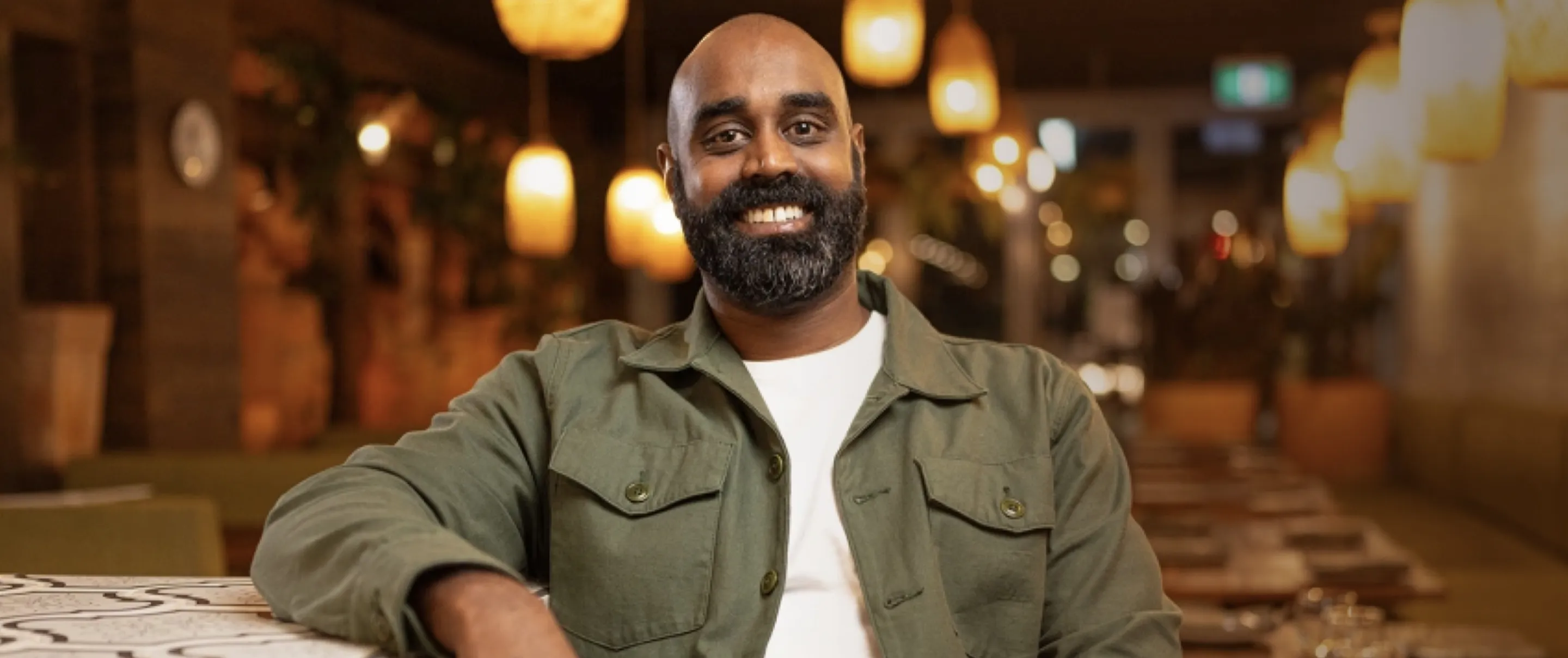 A man sitting at a table in a restaurant.