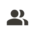 Icon of two overlapping user figures representing teamwork or collaboration.