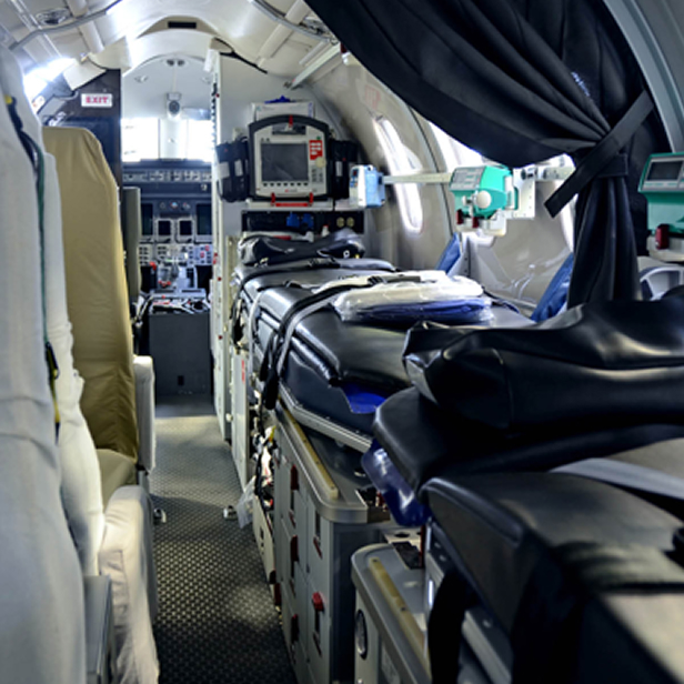 Interior of a medical aircraft with a stretcher and medical equipment inside.