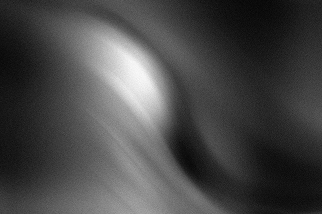Abstract grayscale image with soft, flowing light and shadow patterns.