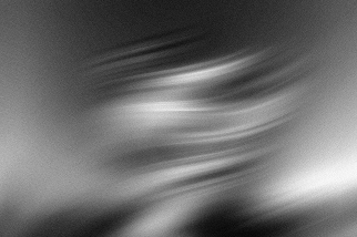 Abstract black and white image with soft blurred streaks and wave-like patterns.