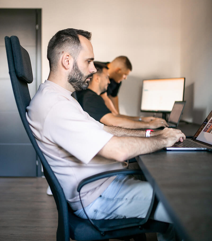 Two people holding up a colorful banner with large letters 'W 7' and text 'Williamstown Theatre Festival' in the center.