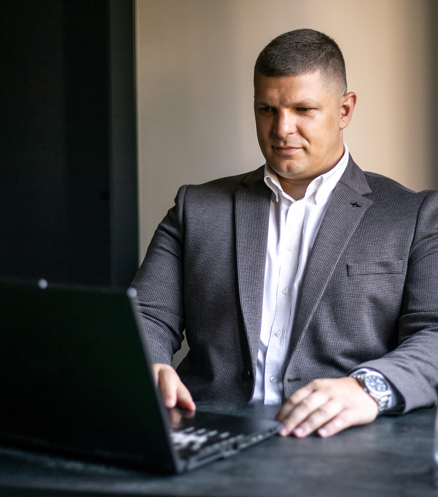 Abstract black and white image with blurred, vertical light streaks resembling smoke or flowing fabric.