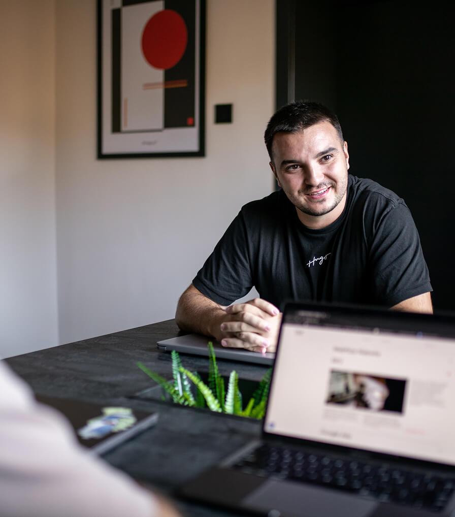 Two people holding up a colorful banner with large letters 'W 7' and text 'Williamstown Theatre Festival' in the center.