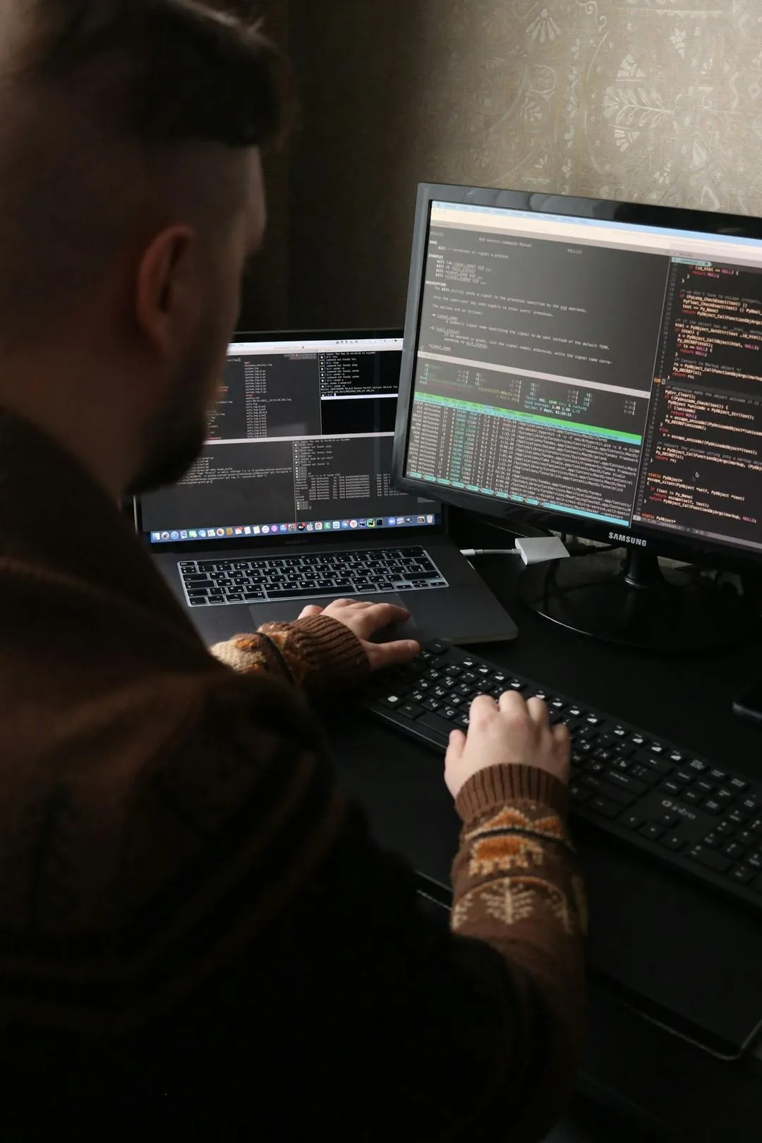 A man coding in his computer.