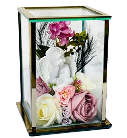 Glass display case with a white cherub statue surrounded by pink, purple, and white roses and greenery.