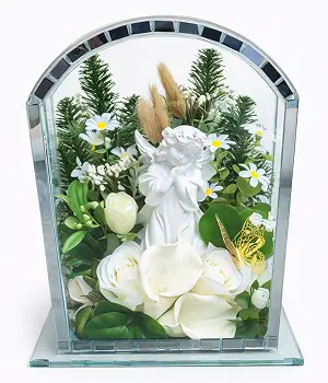Glass shadow box containing a floral arrangement with red roses, white lilies, and green foliage.