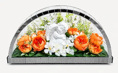 Floral arrangement with a large white rose and yellow flowers framed in a semi-circular mirrored border.