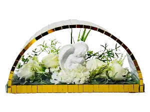 Decorative floral arrangement featuring peach roses and assorted greenery in a half-circle white mosaic container.