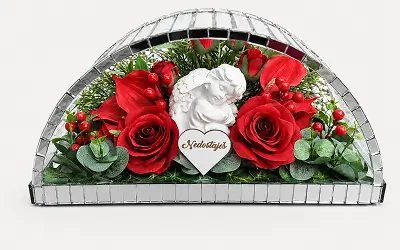 Floral arrangement with a large white rose and yellow flowers framed in a semi-circular mirrored border.