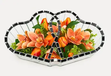 Two connected heart-shaped glass containers with red and white flowers inside.