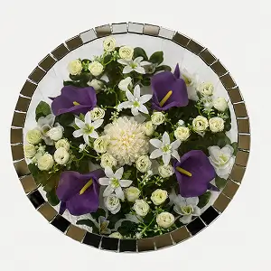 Round glass vase with pink roses, white calla lilies, green button chrysanthemums, and decorative silver pearls.