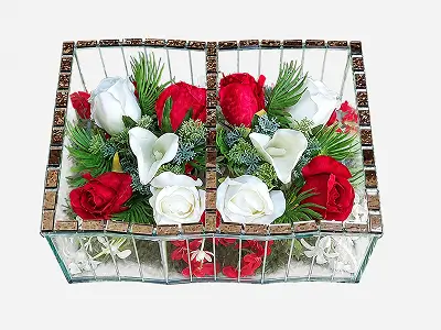 Two transparent glass containers with gold-tinted edges, each holding white and purple artificial flowers with green leaves.