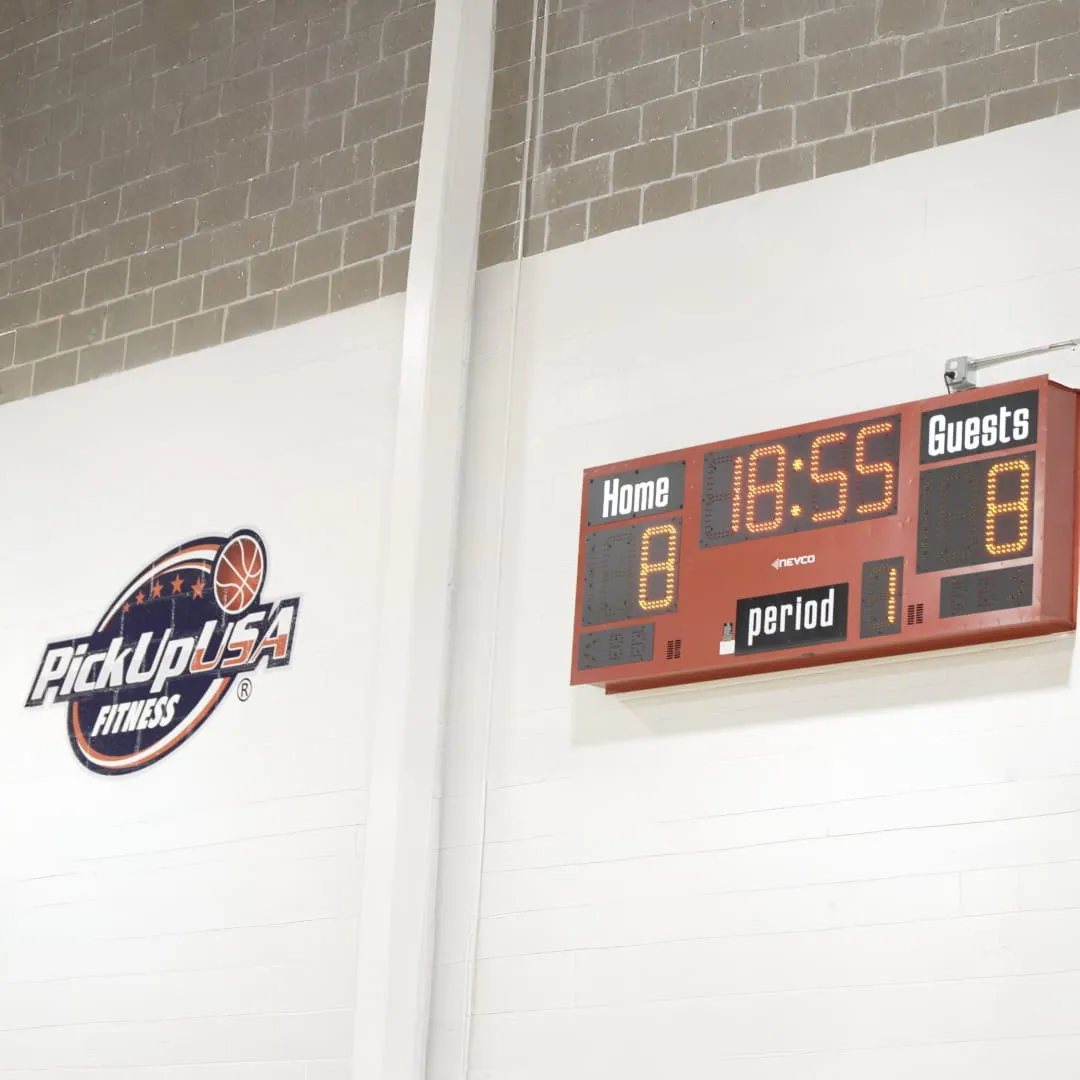 Basketball scoreboard showing tied score 8-8 with 18:55 left in period 1 inside PickUpUSA Fitness gym.