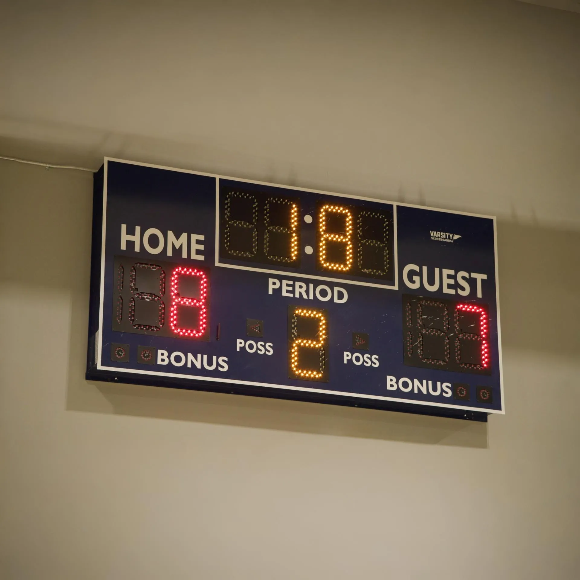 Indoor basketball scoreboard showing Home 18, Guest 17, period 2, with 1 minute 8 seconds on the clock.