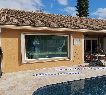 Backyard patio with a large rectangular glass window 