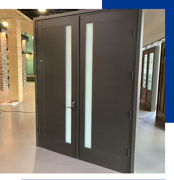Dark brown commercial impact door with vertical frosted glass panels in a showroom setting.