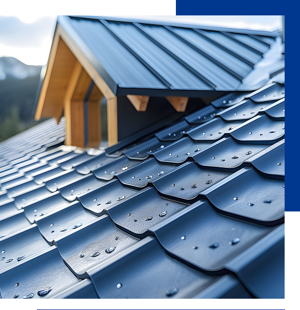 Close-up of a blue metal roof with water droplets and a wooden dormer window in the background.