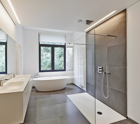 Modern bathroom with a freestanding bathtub by window, double sink vanity, and walk-in shower with glass partition and rain showerhead.