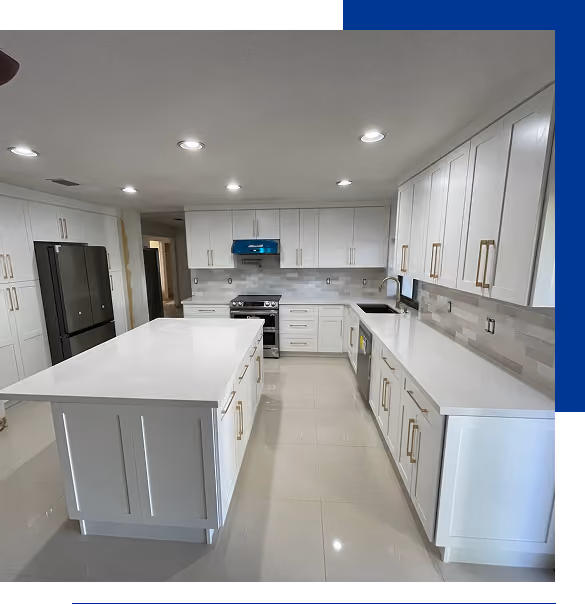 Modern white kitchen with large island, stainless steel appliances, and beige tiled backsplash.