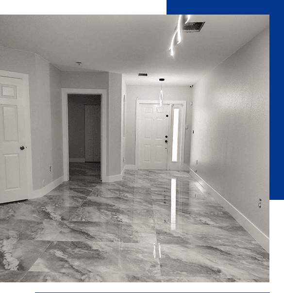 Empty room with polished marble floors, white walls, white doors, and modern ceiling lights.